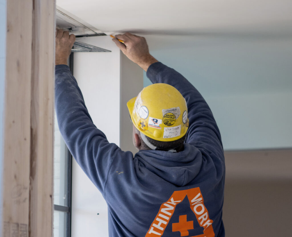 Team member with a hard hat working on a job site