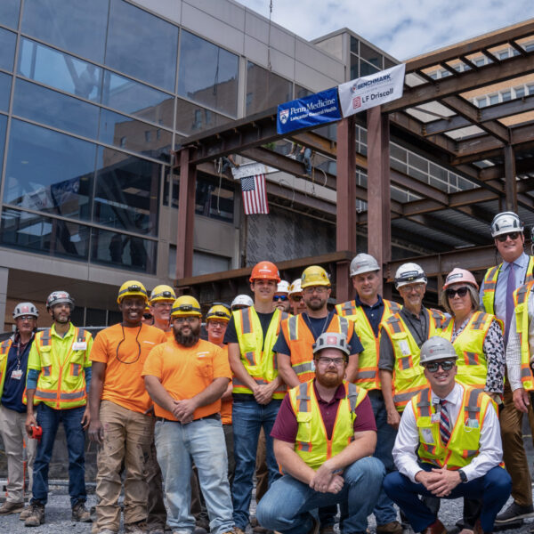 A group of Benchmark team members smile at the camera on a job site