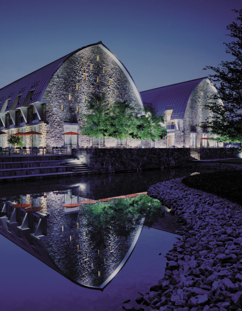 Exterior of two rounded roof buildings with landscaping and water feature at night