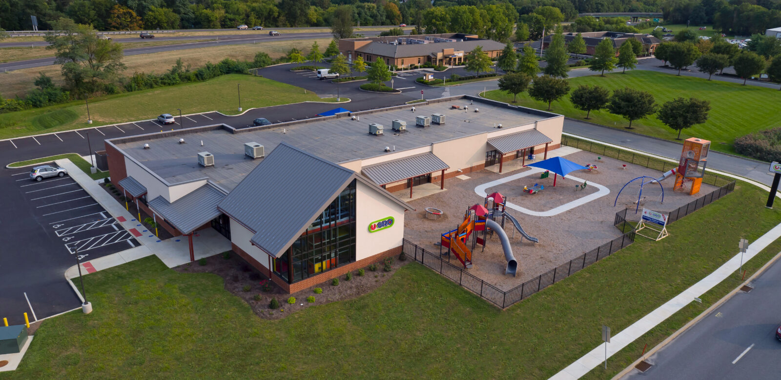 Exterior and aerial shot of a U-Gro education building with playground