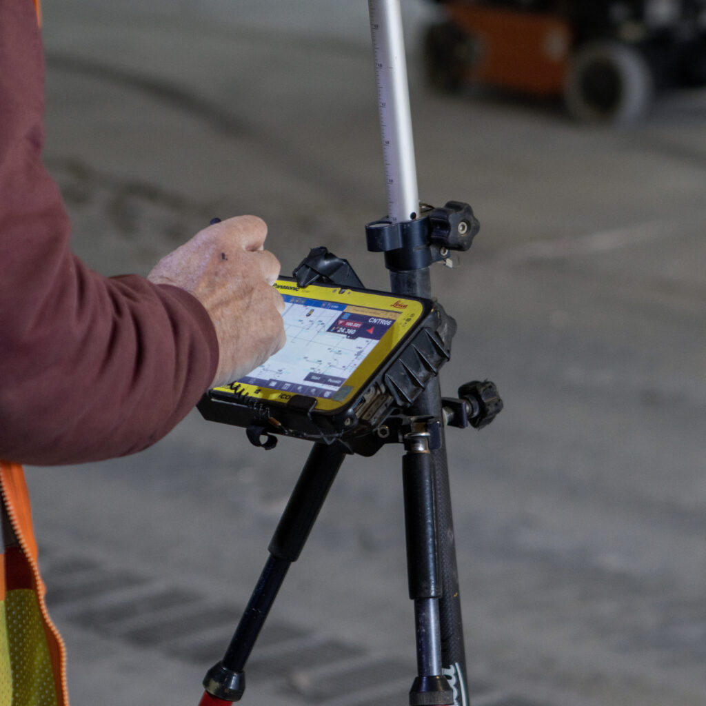 Benchmark team member working with a layout instrument