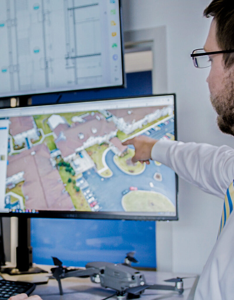 Benchmark team member pointing at a digital plan on a computer