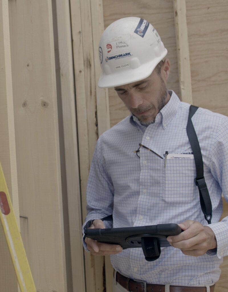 A Benchmark team member reviewing documents on a tablet